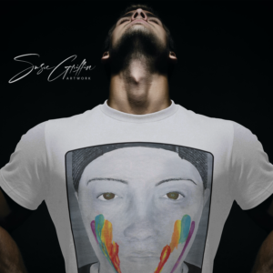 wearing Susie Griffin Artwork's unisex t-shirt with the greyscale image of a face with rainbow striped face paint on the front.